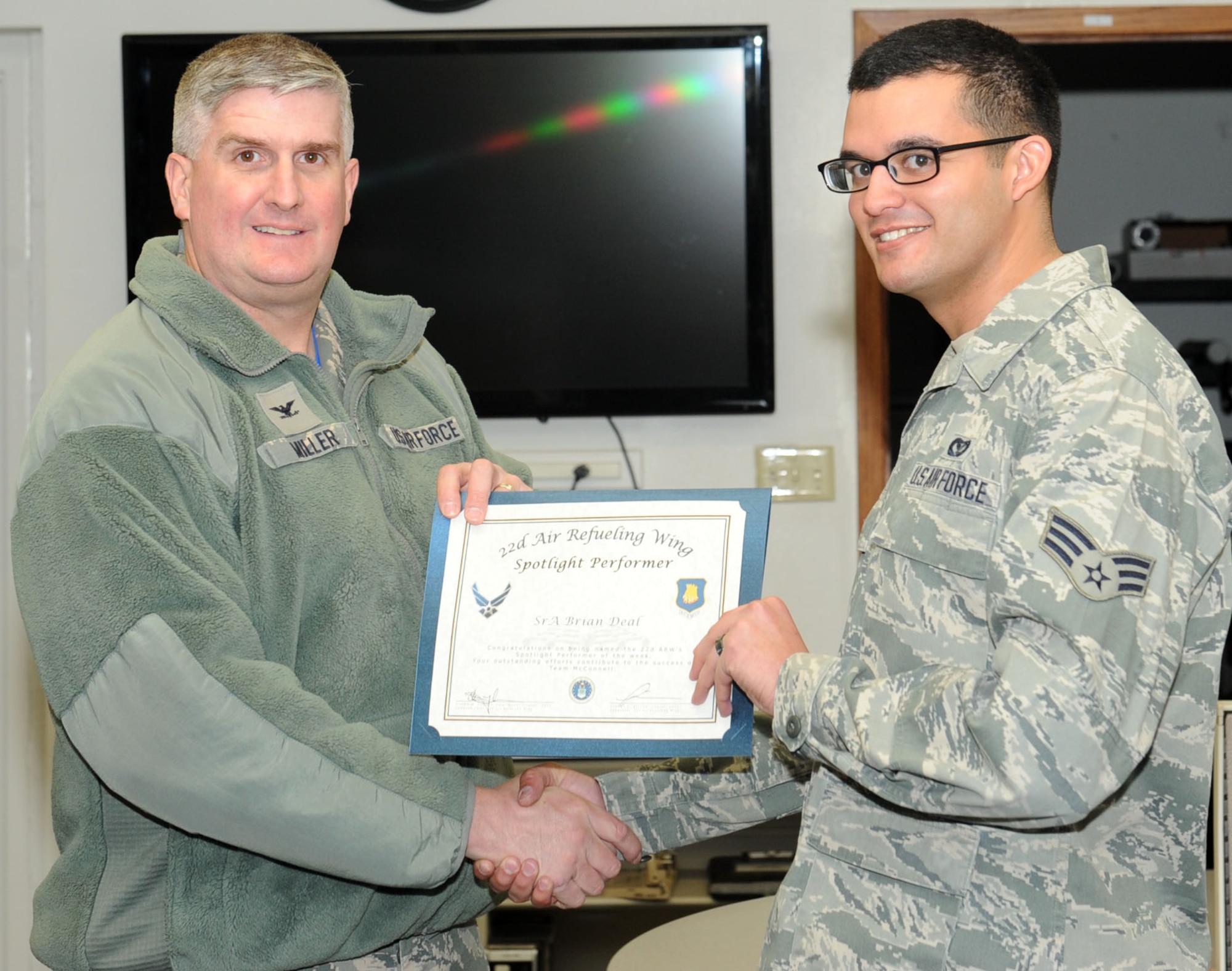 Senior Airman Brian Deal, 22nd Civil Engineer Squadron construction manager, poses with Col. Albert Miller, 22nd Air Refueling Wing commander, Feb. 12, 2016, at McConnell Air Force Base, Kan. Deal is a construction manager for base projects and assists the wing’s program integration office with the KC-46 Pegasus program, providing engineering and drafting support. Deal received the spotlight performer for the week of Feb. 15-19. (U.S. Air Force photo/Senior Airman David Bernal Del Agua)