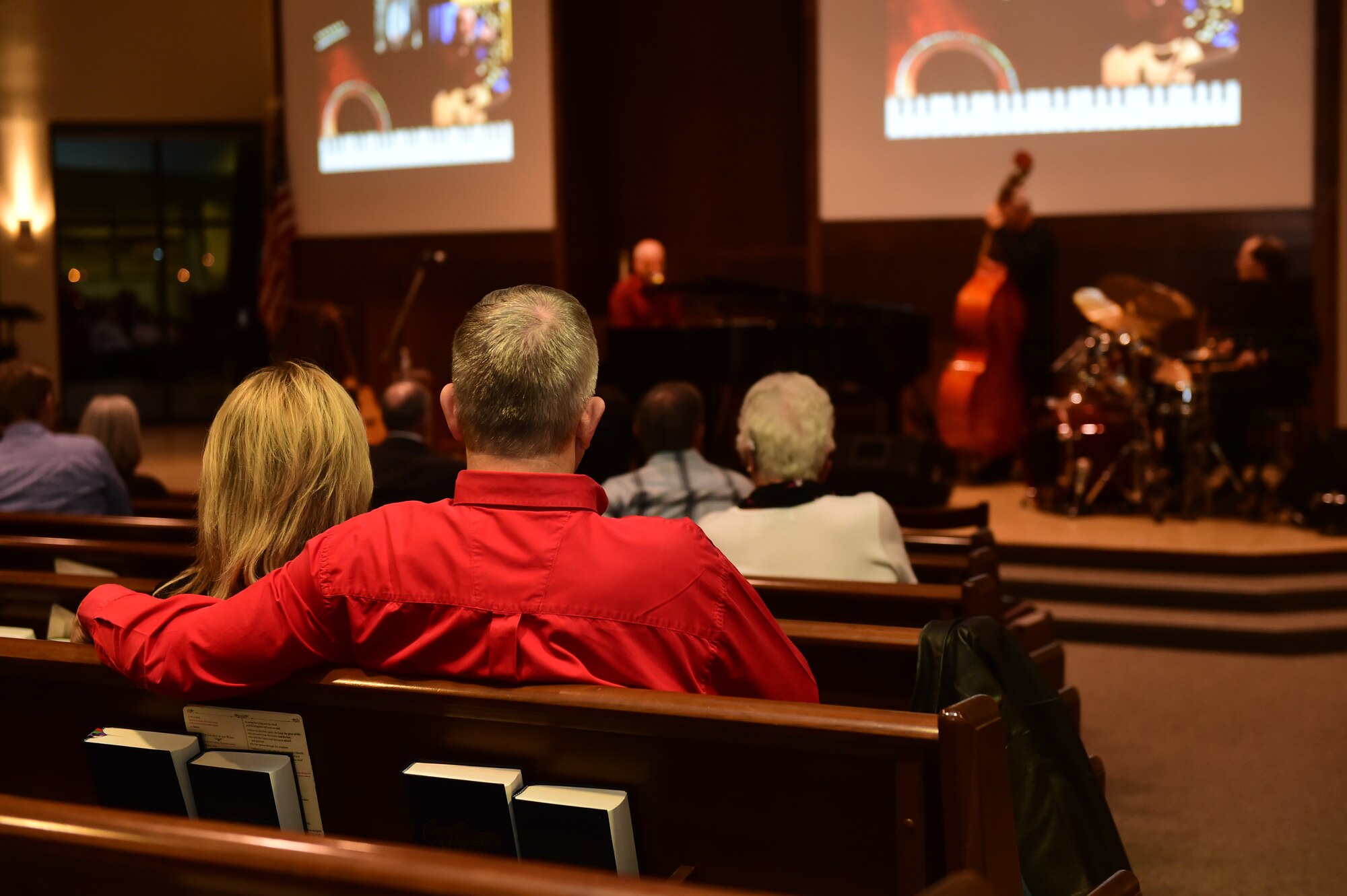 A couple enjoys Danny Byram and his band Feb. 12, 2016, at the Buckley Chapel on Buckley Air Force Base, Colo. Nicknamed “The Combat Musician,” Byram has performed at more than 100 U.S. military installations worldwide, more than any other Christian musician. (U.S. Air Force photo by Airman 1st Class Luke W. Nowakowski/Released)