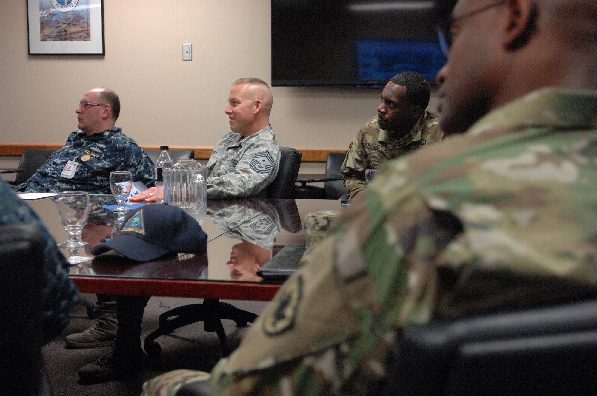 From Left to right, Navy Master Chief Ted Calcaterra, Command Master Chief for Task Force 134 (submarines); North American Aerospace Defense Command and U.S. Northern Command Command First Sergeant, Air Force Chief Master Sgt. Michael Lantz; NORAD and USNORTHCOM J1 Senior Enlisted Leader Army SGM Terrence Burkett and in the foreground NORAD and USNORTHCOM J6 Senior Enlisted Leader Army SGM Jessie Tyson, all listen to a briefing by the Command Master Chief from Naval Station Whidbey Island. The senior enlisted leaders were part of the group of NORAD and USNORTHCOM headquarters SELs who, along with the command senior enlisted leader, Fleet Master Chief Terrence Molidor, traveled to the Pacific Northwest meeting with leadership at Joint Base Lewis McChord, the Washington and Oregon National Guards, emergency managers and Navy Command Northwest learning how their day-to-day missions and emergency plans align with USNORTHCOM. Photo by Air Force Master Sgt. Chuck Marsh/Released  