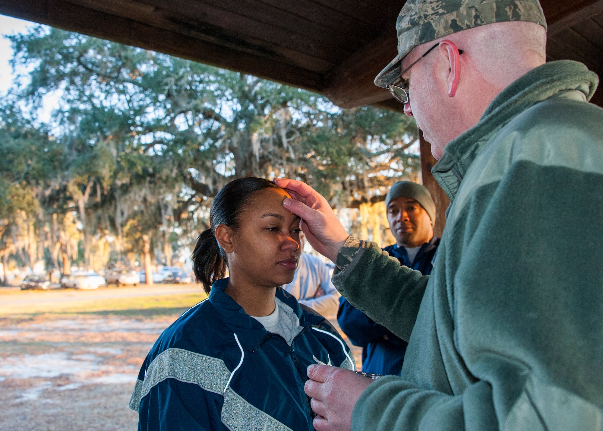 Lt. Col. James Hamel, 96th Test Wing chaplain, makes an optional little black cross of ashes on an Airman during the Ash Wednesday 5K Feb. 10 at Eglin Air Force Base, Fla. Approximately 115 runners and 15 volunteers endured a 29-degree temperature to participate in the run. Ash Wednesday marks the beginning of the Lent season for Christians. (U.S. Air Force photo/Ilka Cole)
