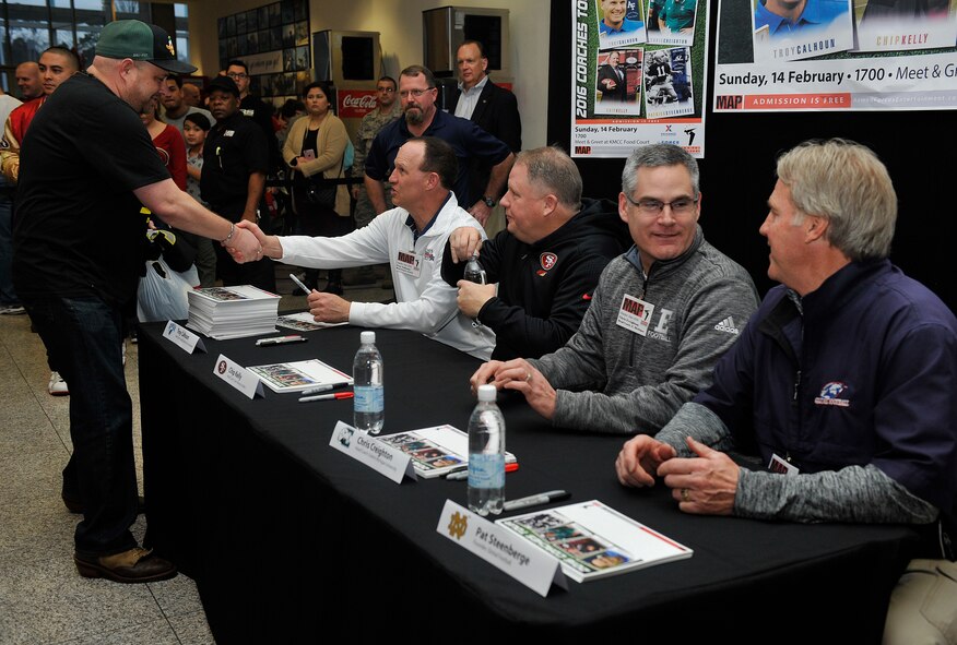 Football coaches meet fans during the 2016 Coaches Tour Feb. 14, 2016, at Ramstein Air Base, Germany. The coaches who attended the tour are Troy Calhoun, Air Force Academy head coach, Chip Kelly, San Francisco 49ers head coach, Chris Creighton, Eastern Michigan University head coach, and Patrick Steenberge, Global  Football founder. (U.S. Air Force photo/Airman 1st Class Larissa Greatwood) 