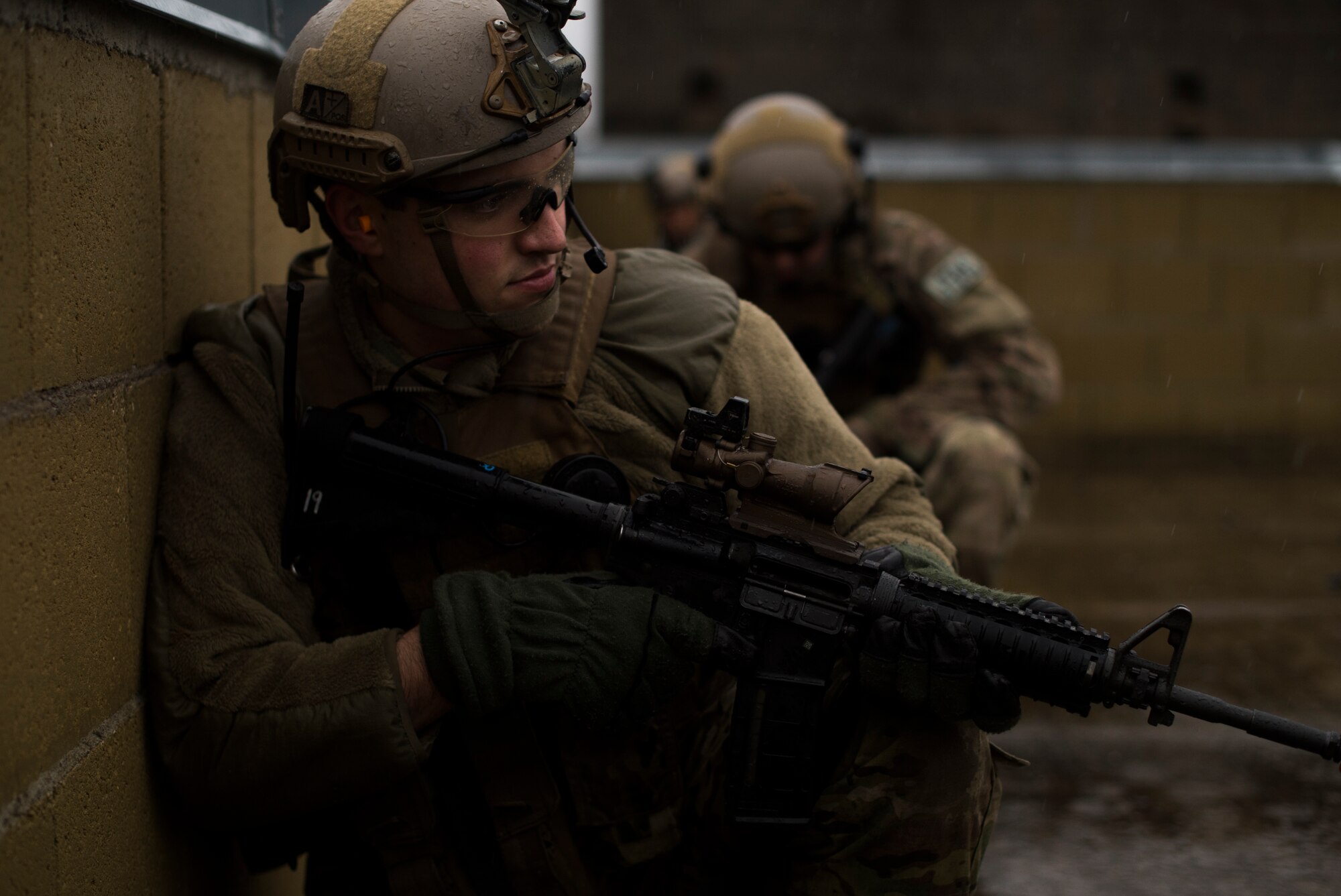 Senior Airman Tormod Lillekroken, 2nd Air Support Operations Squadron tactical air control party, takes cover on a roof top with his team during training at U.S. Army Garrison Bavaria in Vilseck, Germany, Feb. 9, 2016. The training consisted of 2nd ASOS Airmen calling in close air support, neutralizing opposing forces and practicing medical evacuation by helicopter. The Airmen swapped roles as opposing forces and U.S. forces throughout the training to challenge their capabilities in controlling air power in an urban environment. (U.S. Air Force photo/Senior Airman Jonathan Stefanko)