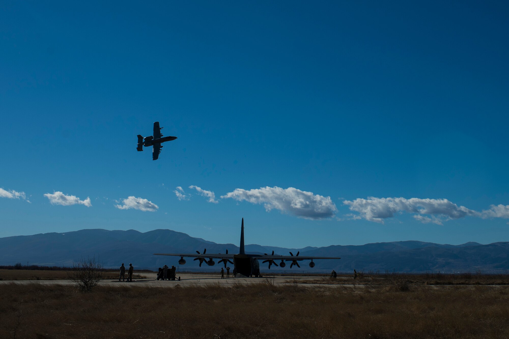 A 74th Expeditionary Fighter Squadron A-10C Thunderbolt II aircraft flies over an MC-130J Commando II aircraft, assigned to the 67th Special Operations Squadron, during a training exercise at Plovdiv, Bulgaria, Feb. 11, 2016. The aircraft deployed to Bulgaria in support of Operation Atlantic Resolve to bolster air power capabilities while assuring the U.S. commitment to European security and stability. (U.S. Air Force photo by Airman 1st Class Luke Kitterman/Released)