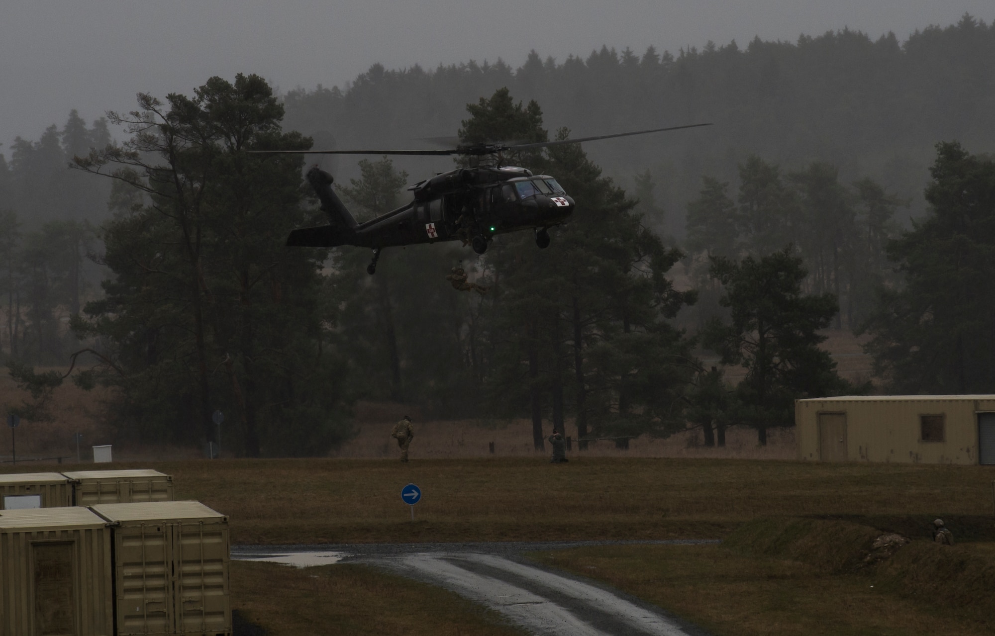 A simulated casualty is hoisted onto an UH-60 for medical evacuation during joint terminal attack controller training at U.S. Army Garrison Bavaria in Vilseck, Germany, Feb. 9, 2016. The training consisted of 2nd Air Support Operations Squadron Airmen calling in close air support, neutralizing opposing forces and practicing medical evacuation by helicopter. (U.S. Air Force photo/Senior Airman Jonathan Stefanko)