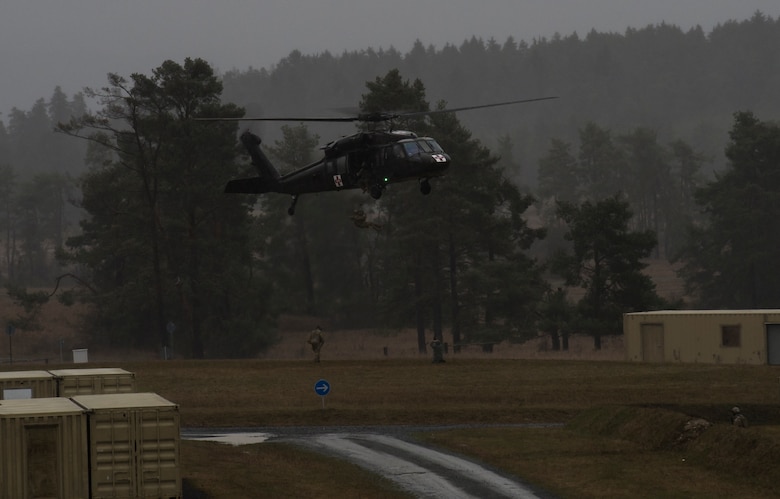 A simulated casualty is hoisted onto an UH-60 for medical evacuation during joint terminal attack controller training at U.S. Army Garrison Bavaria in Vilseck, Germany, Feb. 9, 2016. The training consisted of 2nd Air Support Operations Squadron Airmen calling in close air support, neutralizing opposing forces and practicing medical evacuation by helicopter. (U.S. Air Force photo/Senior Airman Jonathan Stefanko)