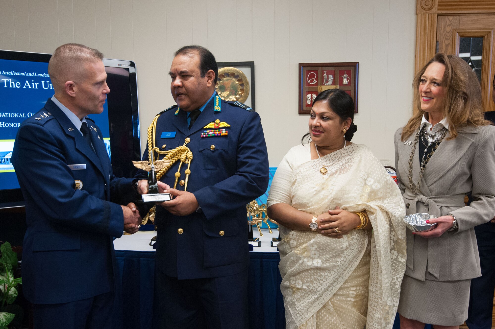 Air Force Lt. Gen. Steven Kwast, Air University commander and president, presents an award to a student attending the International Officer School at the Carl A. Spaatz Center for Officer Education, Feb. 3, 2016. The international officers receive the awards to honor select alumni who have attained prominent positions in their countries. The selection of each award is based on input from the embassy of the individuals’ country. 