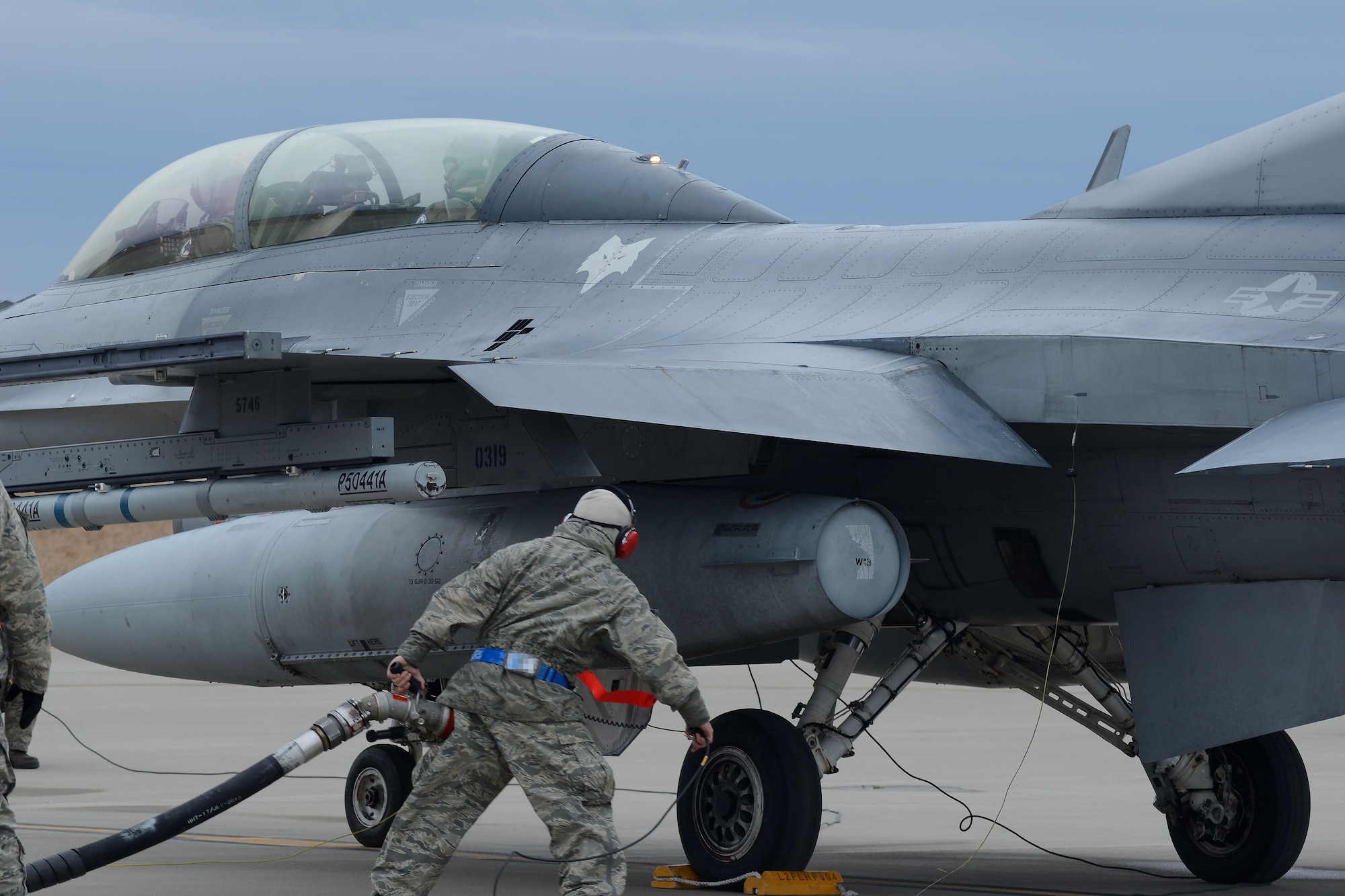 U.S. Air Force Senior Airman Jeremy Jimenez, a crew chief assigned to the 169th Aircraft Maintenance Squadron of the South Carolina Air National Guard, connects a fuel hose to an F-16 Fighting Falcon fighter jet during “hot-pit” ground refueling training on the flight line at McEntire Joint National Guard Base, S.C., Feb. 7, 2016.  Ground refueling while the engine is running, allows aircraft to return to flight quickly during sortie operations and combat missions. (U.S. Air National Guard photo by Senior Airman Ashleigh S. Pavelek)