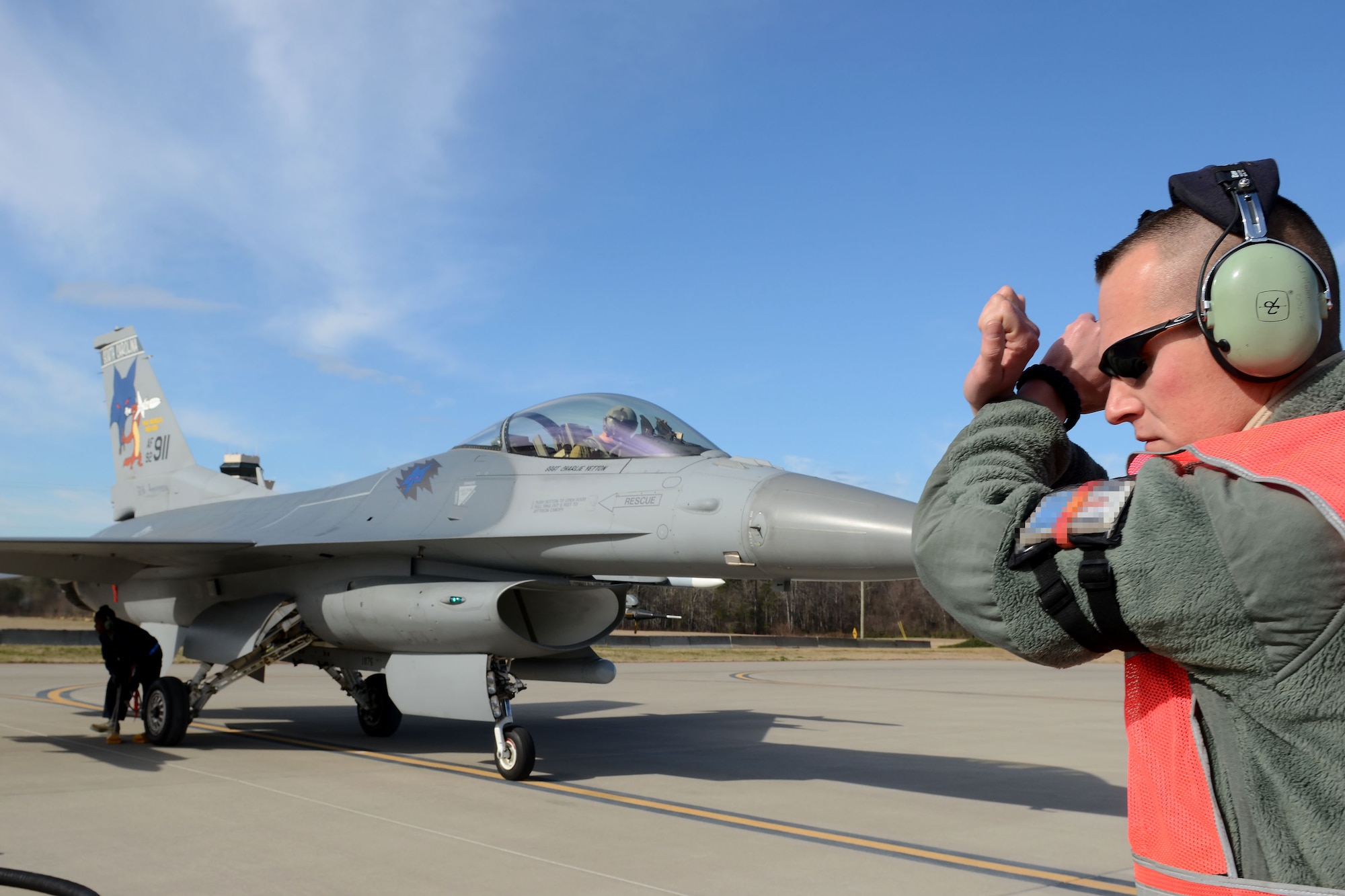 U.S. Air Force Tech. Sgt. John Moler, a crew chief assigned to the 169th Aircraft Maintenance Squadron of the South Carolina Air National Guard, directs the pilot of an F-16 Fighting Falcon fighter jet during “hot-pit” ground refueling training on the flight line at McEntire Joint National Guard Base, S.C., Feb. 6, 2016.  Ground refueling while the engine is running, allows aircraft to return to flight quickly during sortie operations and combat missions. (U.S. Air National Guard photo by Senior Airman Ashleigh S. Pavelek)