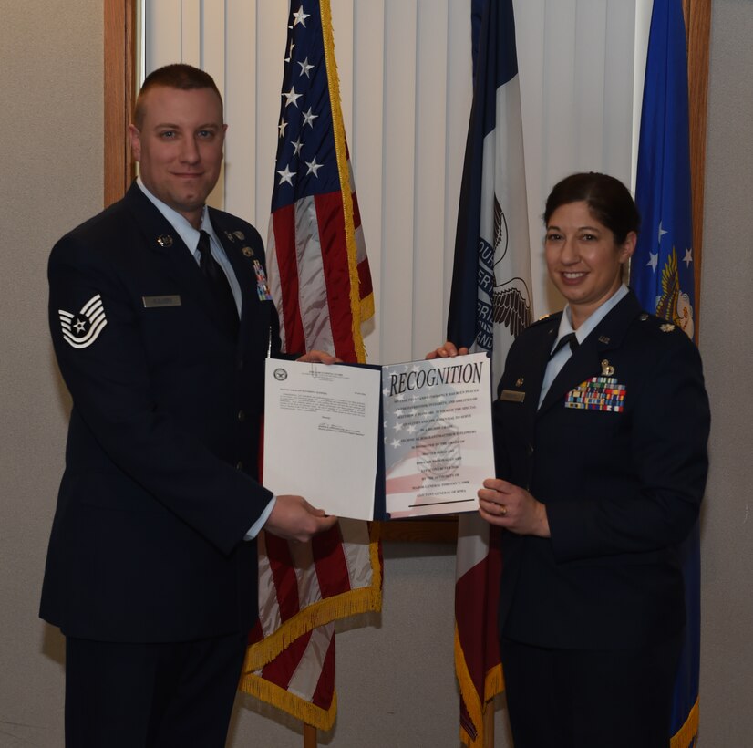 Tech Sgt. Matthew Flowers is promoted to the rank of Master Sgt. by Lt. Col. Alexandra Greenfield. The event took place at the 132d Wing Classroom. (U.S. Air National Guard photo by Staff Sgt. Matthew T. Doyle/Released)