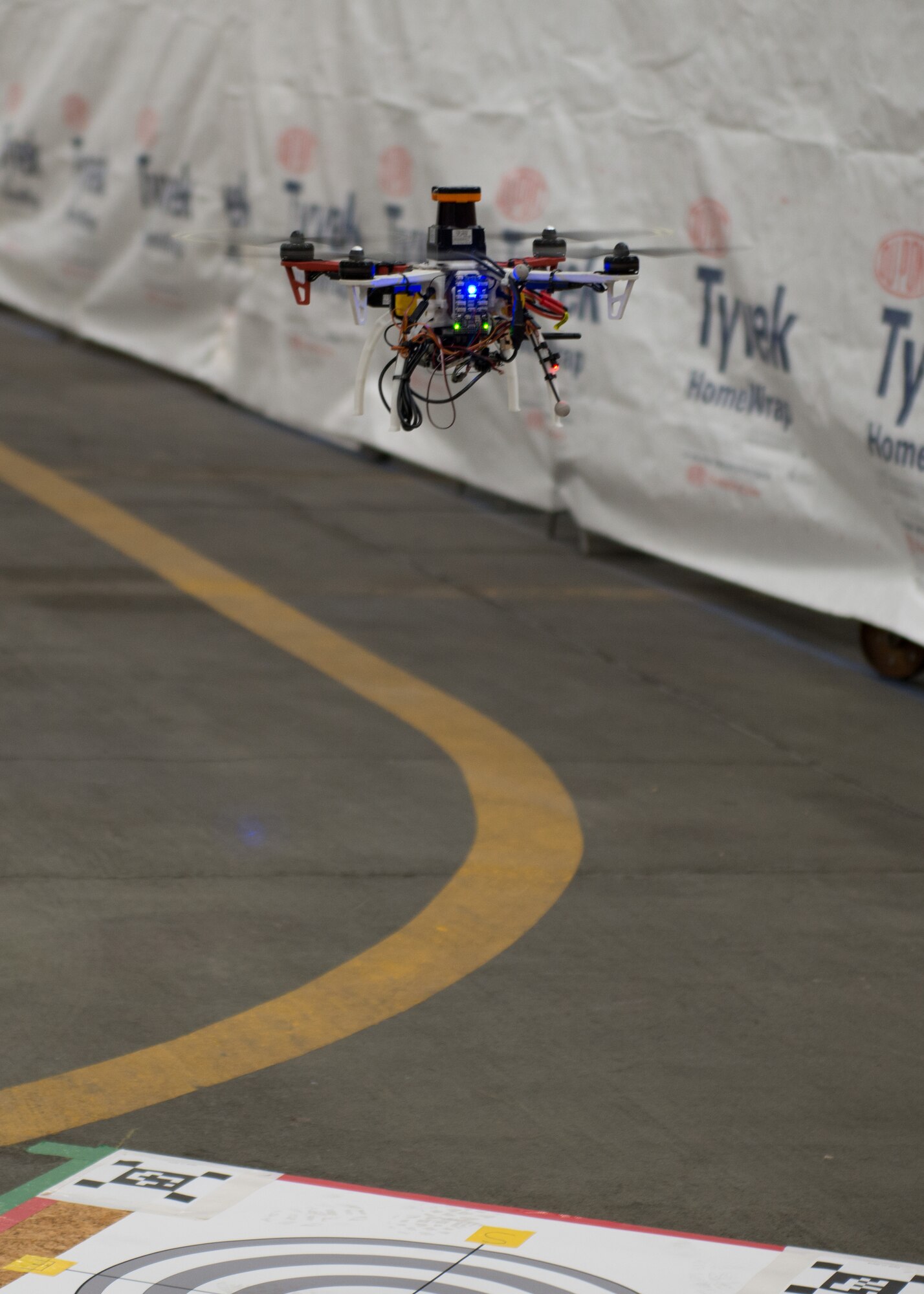 Members of Defense Advanced Research Projects Agency's (DARPA) Fast Lightweight Autonomy (FLA) program used the 102nd Intelligence Wing's hangar to test small UAVs in an indoor, controlled environment. (U.S. Air National Guard photo by Mr. Timothy Sandland/Released)