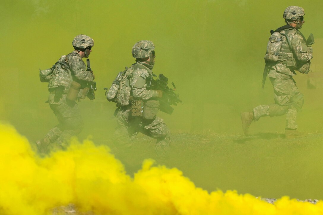 Army paratroopers run through smoke to mask their movements while assaulting an objective at the Peason Ridge area of Fort Polk, La., Feb. 13, 2016. Army photo by Staff Sgt. Sean Brady