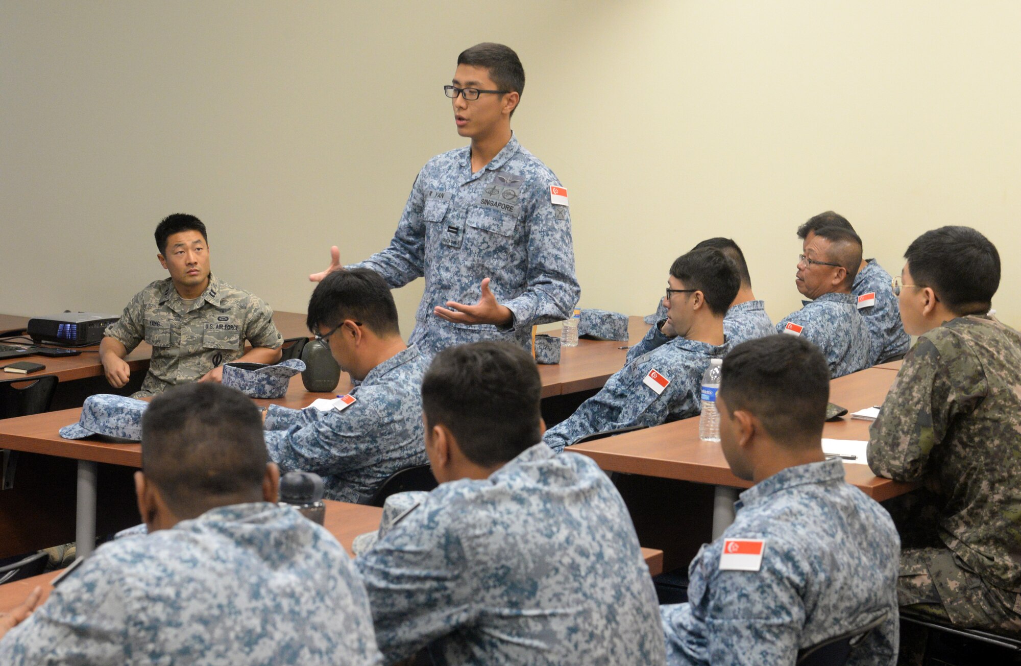 An Airman from the Republic of Singapore Air Force introduces himself to other Partner Nation Silver Flag students Feb. 13, 2016, at Andersen Air Force Base, Guam. Silver Flag is a U.S. Pacific Command multilateral Theater Security Cooperation Program subject matter expert exchange event designed to build partnerships and promote interoperability through the equitable exchange of civil engineer related information. This is the first multilateral Partner Nation Silver Flag. (U.S. Air Force photo/Senior Airman Joshua Smoot)