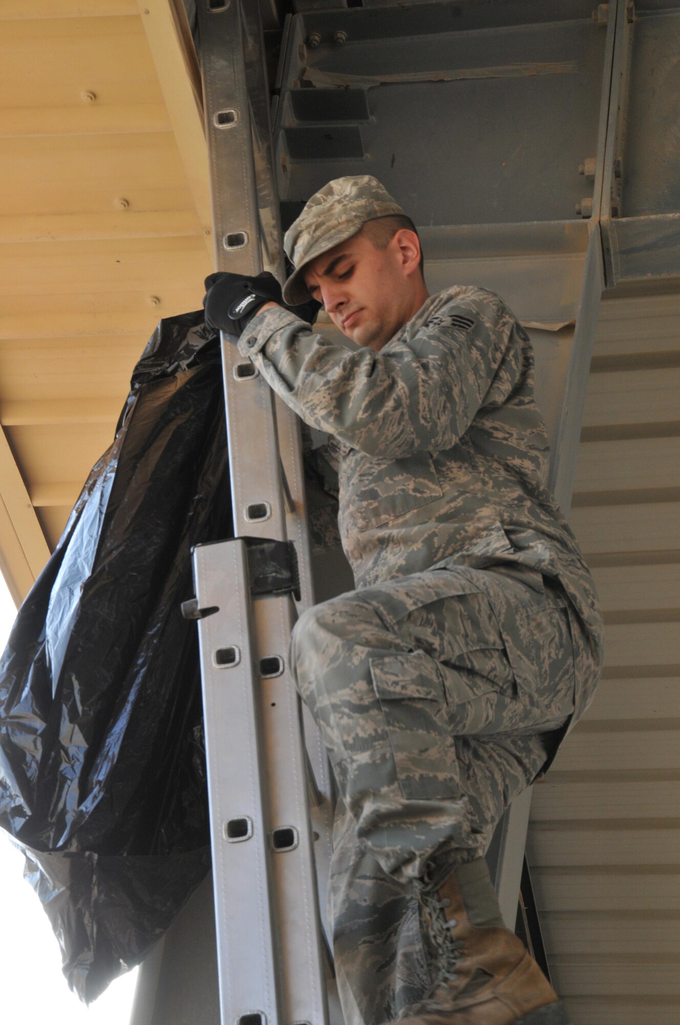 Senior Airman Jonathan McDonald, 379th Expeditionary Civil Engineer Squadron pest management technician, conducts aircraft damage prevention by cleaning areas of pests Feb. 8 at Al Udeid Air Base, Qatar. Pigeons and doves caused 35 percent of bird strikes at AUAB in 2015. (U.S. Air Force photo by Tech. Sgt. Terrica Y. Jones/Released)
