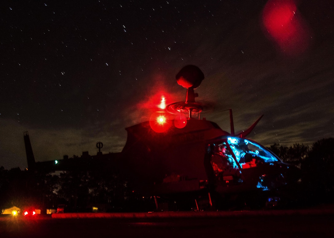 Soldiers and pilots prepare to provide fuel and ammunition to an OH-58 Kiowa Warrior helicopter before a night live-fire exercise on Marine Corps Outlying Field Atlantic, N.C., Feb. 8, 2016. The soldiers and pilots are assigned to the 82nd Airborne Division’s 17th Cavalry Regiment, 82nd Combat Aviation Brigade. Army photo by Staff Sgt. Christopher Freeman
