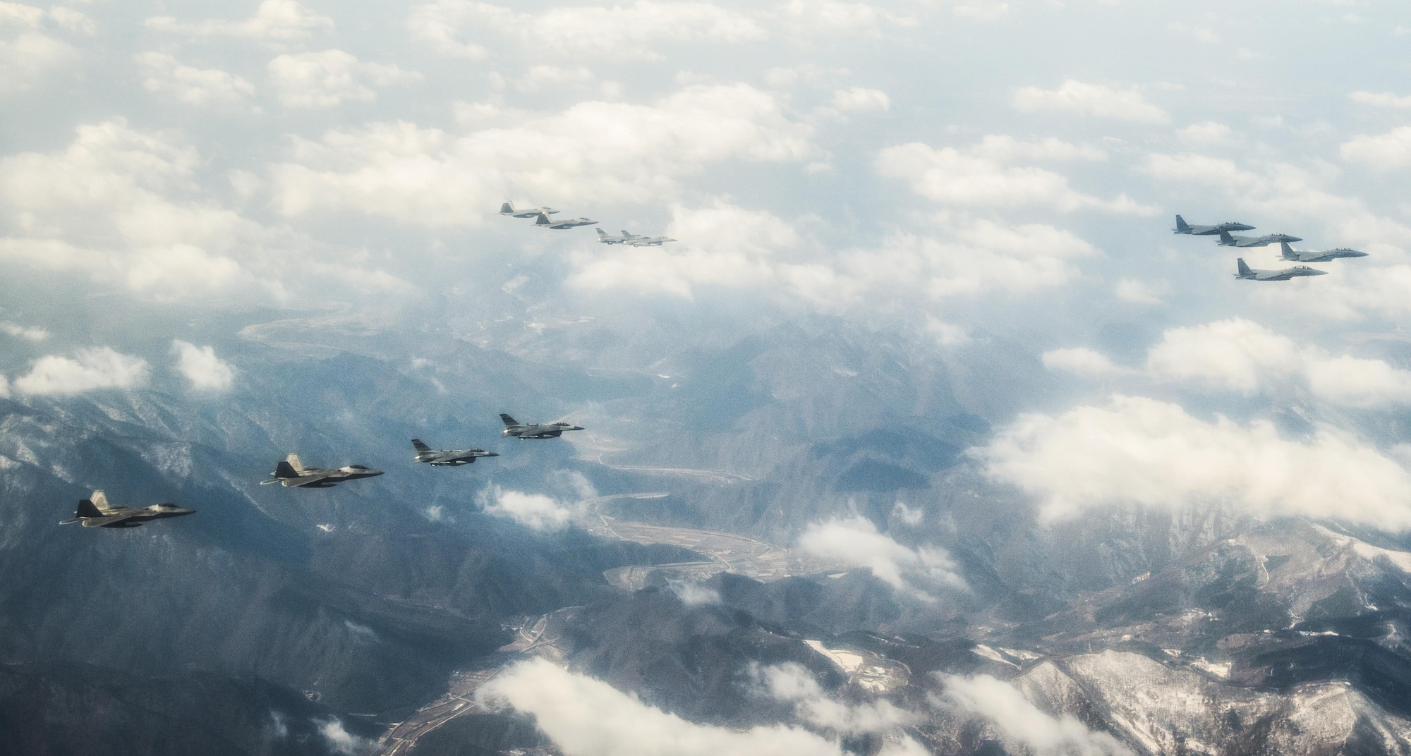 Four U.S. Air Force F-22 "Raptor" fighter aircraft from Kadena Air Base, Japan, fly over the skies of South Korea, in response to recent provocative action by North Korea Feb. 17, 2016. The Raptors were joined by four F-15 Slam Eagles and U.S. Air Force F-16 Fighting Falcons. The F-22 is designed to project air dominance rapidly and at great distances and currently cannot be matched by any known or projected fighter aircraft.  (U.S. Air Force photo by Airman 1st Class Dillian Bamman/Released)