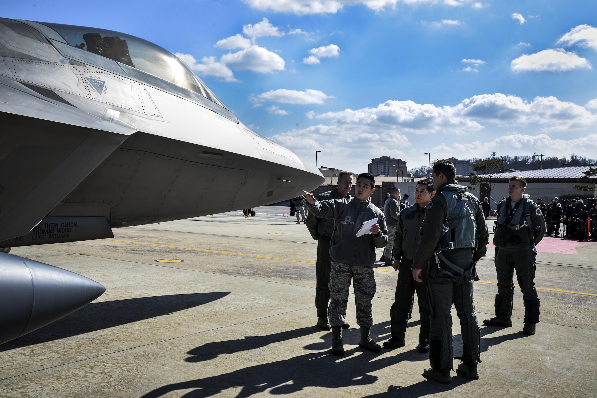 Chief of Staff of the Republic of Korea air force Gen. Jeong, Kyeong-doo (middle) receives a translated briefing from an F-22 Raptor pilot after conducting a flyover in the vicinity of Osan Air Base, South Korea, in response to recent provocative action by North Korea Feb. 17, 2016. F-22 Raptors were joined by four F-15 Slam Eagles and U.S. Air Force F-16 Fighting Falcons. The F-22 is designed to project air dominance rapidly and at great distances and currently cannot be matched by any known or projected fighter aircraft.  (U.S. Air Force photo by Tech. Sgt. Travis Edwards/Released)
