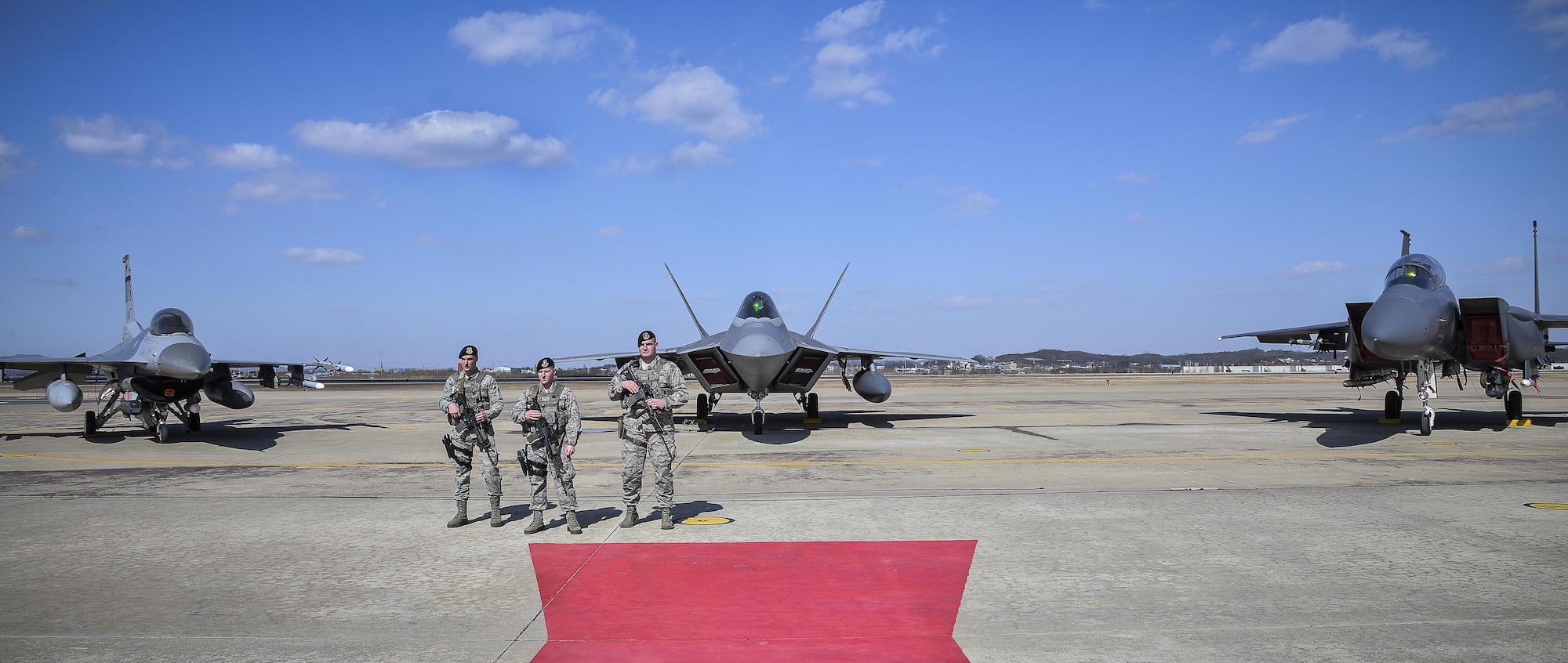 Air Force Security Forces members stands guard next to an F22 Raptor fighter aircraft from Kadena Air Base, Japan, after it conducted a flyover in the vicinity of Osan Air Base, South Korea, in response to recent provocative action by North Korea Feb. 17, 2016. It was joined by three other Raptors, four F-15 Slam Eagles and four U.S. Air Force F-16 Fighting Falcons. The F-22 is designed to project air dominance rapidly and at great distances and currently cannot be matched by any known or projected fighter aircraft.  (U.S. Air Force photo by Tech. Sgt. Travis Edwards/Released)