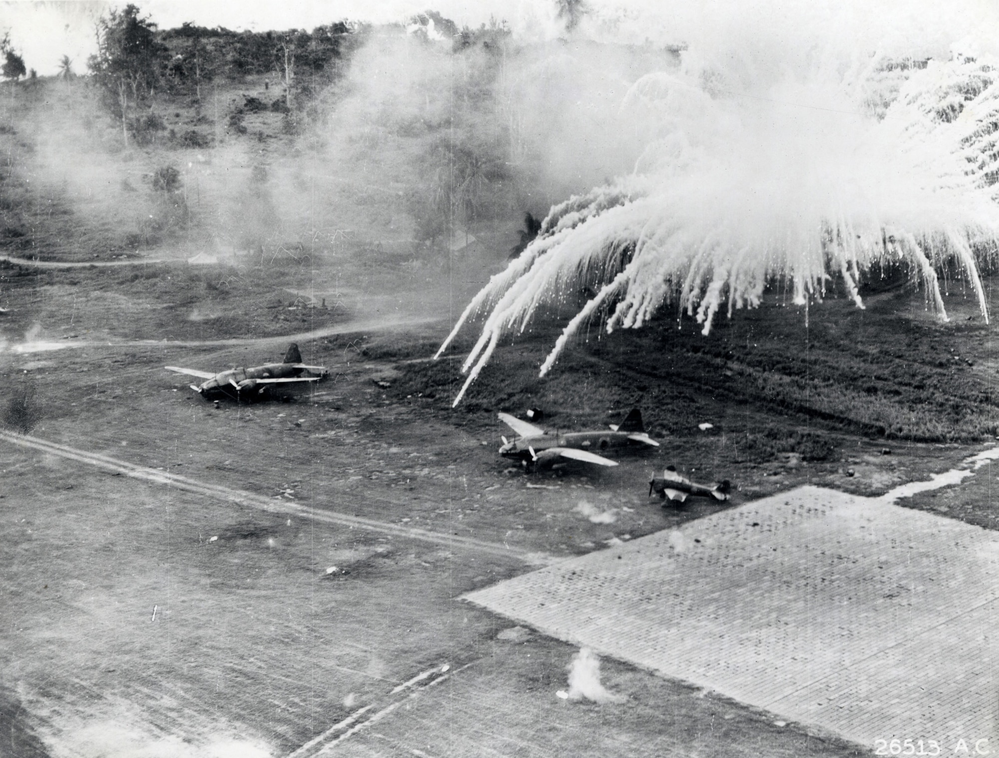 The result of phosphorus bombs and how they worked on a Betty and a Zeke on Lakunai Field during the attack at Rabaul. (U.S. Air Force photo)