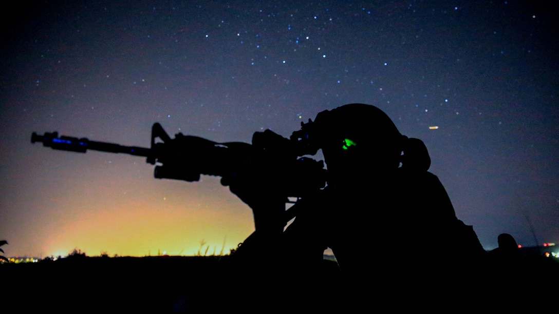 A Marine provides security for his team during the night portion of a tactical recovery of aircraft and personnel, or TRAP, training scenario at Marine Corps Base Camp Pendleton, California, Feb. 8, 2016. TRAP is used to tactically recover personnel, equipment or aircraft by inserting the recovery force to the objective location. The Marine is with Weapons Company, 2nd Battalion, 4th Marine Regiment, 1st Marine Division.