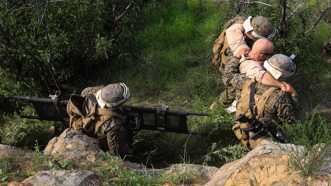 A Marine aid and litter team retrieves a simulated down pilot during a tactical recovery of aircraft and personnel, or TRAP, training scenario at Camp Pendleton, Calif., Feb. 10, 2016. In preparation for their upcoming deployment with the 31st Marine Expeditionary Unit, the TRAP scenario offers the Marines of Weapons Company, 2nd Battaion, 4th Marine Regiment, 1st Marine Divison, a secondary skillset in additon to their own primary duties, refining their ability to efficiently conduct a recovery mission. (U.S. Marine Corps photo by Lance Cpl. Devan K. Gowans/Released)
