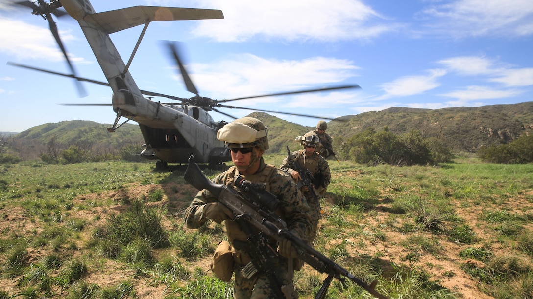 Marines offload from a CH-53E Super Stallion transport helicopter to retrieve a simulated injured pilot during a tactical recovery of aircraft and personnel, or TRAP, training scenario at Camp Pendleton, Calif., Feb. 10, 2016. In preparation for their upcoming deployment with the 31st Marine Expeditionary Unit, the TRAP scenario offers the Marines of 2nd Battalion, 4th Marine Regiment, 1st Marine Division, a secondary skillset above their own primary duties as a 81mm mortar platoon, refining their ability to efficiently conduct a recovery mission. (U.S. Marine Corps photo by Lance Cpl. Devan K. Gowans/Released)