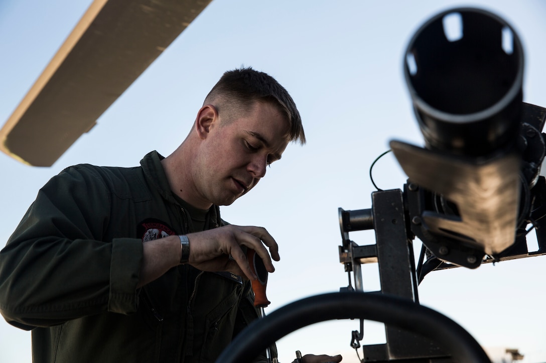Sgt. Benjamin Hebert, a crew chief with Marine Light Attack Helicopter Squadron 469 (HMLA-469) based out of Marine Corps Air Station Camp Pendleton, Calif., performs maintenance on a UH-1Y “Venom” helicopter aboard Marine Corps Air Station Yuma, Ariz., Friday, Feb. 5, 2016.