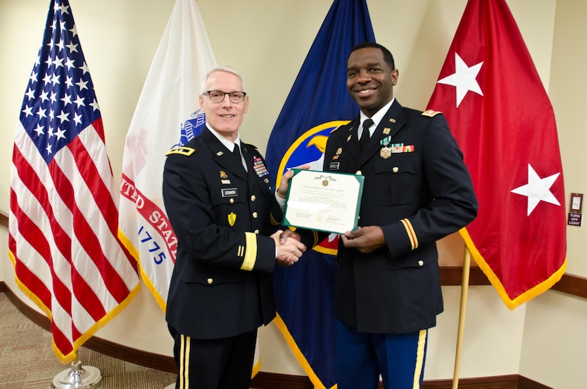 Maj. Gen. Peter S. Lennon, Deputy Commanding General (Support), U.S. Army Reserve, presents Capt. Edgar Borgella, course director assigned to the 83rd U.S. Army Reserve Readiness Training Center, with an Army Commendation Award for his selection as the U.S. Army Reserve Instructor of the Year (Officer), at USARC headquarters, Feb. 11, 2016. Borgella was honored alongside winners from the noncommissioned officer and warrant officer category, in the first USARC hosted Instructor of the Year Ceremony held here. (U.S. Army Reserve photo by Brian Godette, USARC Public Affairs)