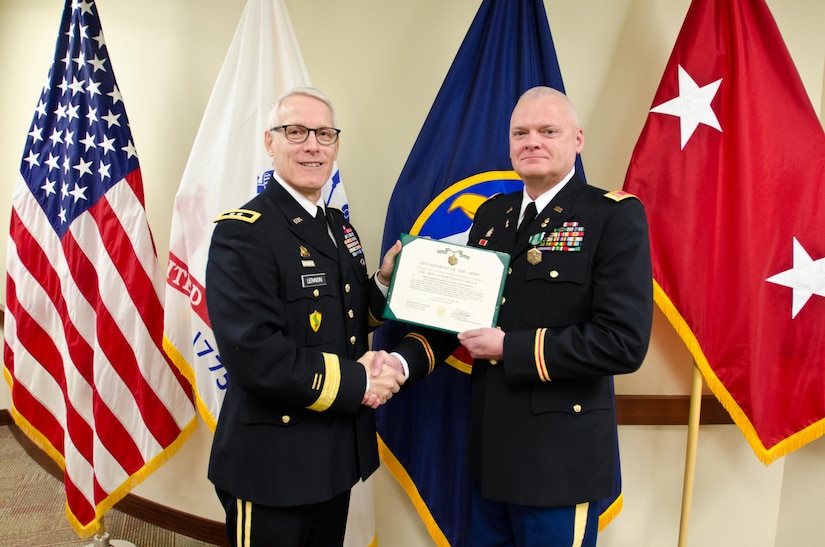 Maj. Gen. Peter S. Lennon, Deputy Commanding General (Support), U.S. Army Reserve, presents Chief Warrant Officer 4 David Griffin, chief instructor assigned to the 83rd U.S. Army Reserve Readiness Training Center, with an Army Commendation Award for his selection as the U.S. Army Reserve Instructor of the Year (Warrant Officer), at USARC headquarters, Feb. 11, 2016. Griffin was honored alongside winners from the noncommissioned officer and officer category, in the first USARC hosted Instructor of the Year Ceremony held here.(U.S. Army Reserve photo by Brian Godette, USARC Public Affairs)