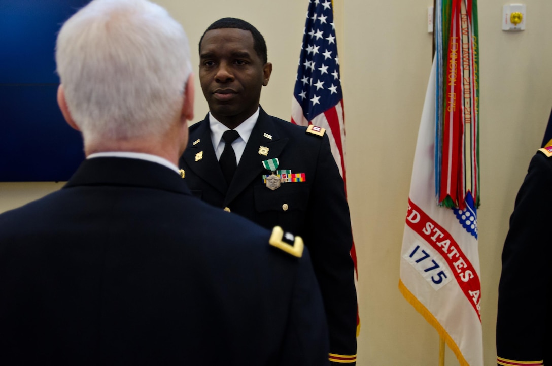 Maj. Gen. Peter S. Lennon, Deputy Commanding General (Support), U.S. Army Reserve, presents Capt. Edgar Borgella, course director assigned to the 83rd U.S. Army Reserve Readiness Training Center, with an Army Commendation Award for his selection as the U.S. Army Reserve Instructor of the Year (Officer), at USARC headquarters, Feb. 11, 2016. Borgella was honored alongside winners from the noncommissioned officer and warrant officer category, in the first USARC hosted Instructor of the Year Ceremony held here. (U.S. Army Reserve photo by Brian Godette, USARC Public Affairs)