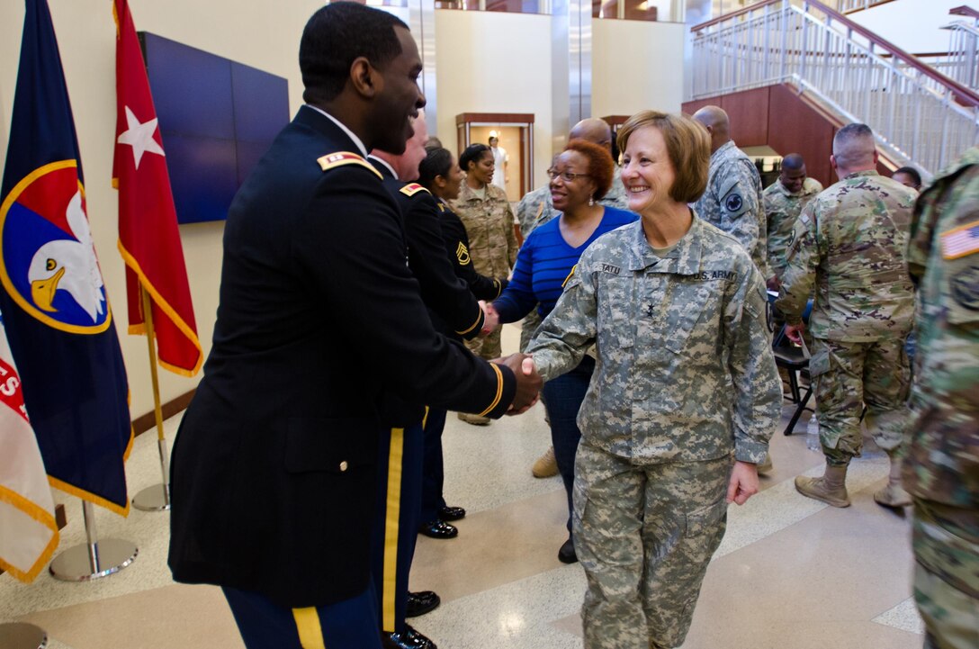 Maj. Gen. Megan Tatu, Chief of Staff, U.S. Army Reserve, congratulates Capt. Edgar Borgella, course director assigned to the 83rd U.S. Army Reserve Readiness Training Center, for his selection as the U.S. Army Reserve Instructor of the Year (Officer), at USARC headquarters, Feb. 11, 2016. Borgella was honored alongside winners from the noncommissioned officer and warrant officer category, in the first USARC hosted Instructor of the Year Ceremony held here. (U.S. Army Reserve photo by Brian Godette, USARC Public Affairs)