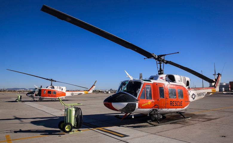 Two HH-1N “Huey” helicopters sit on the grounds outside of the Search and Rescue hangar aboard Marine Corps Air Station Yuma, Ariz., Friday, Feb. 12, 2016. The MCAS Yuma SAR team hosted a conference with regional emergency services personnel to discuss tactics, techniques and procedures.