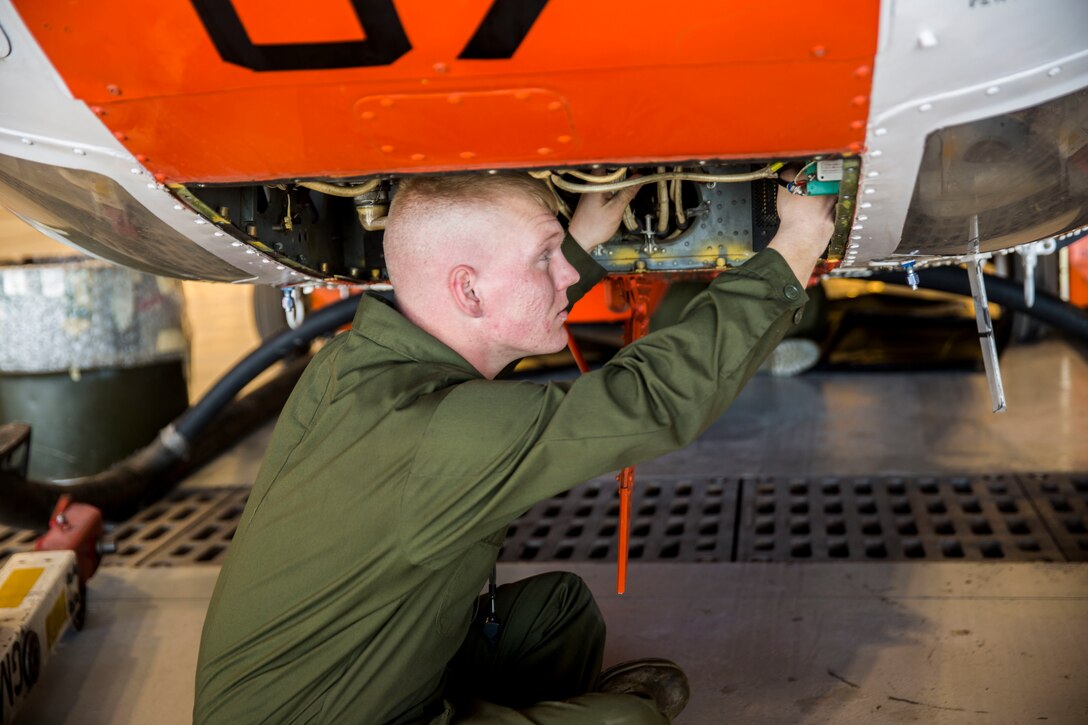 Lance Cpl. Kalib Turner, a corrosion treatment avionics technician chief with Headquarters and Headquarters Squadron Search and Rescue (SAR), stationed out of Marine Corps Air Station Yuma, Ariz., checks for corrosion in the circuit breaker box of a HH-1N “Huey” helicopter in the SAR hangar, Thursday, Feb. 4, 2016.
