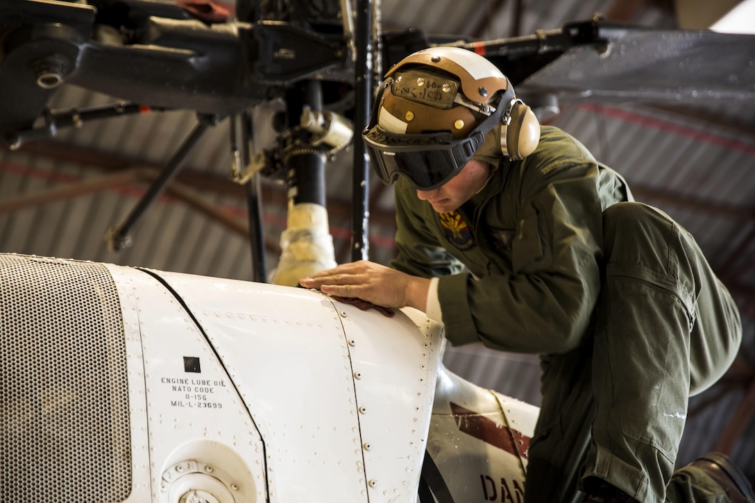 Lance Cpl. Jake Boyer, a crew chief with Headquarters and Headquarters Squadron Search and Rescue (SAR), stationed out of Marine Corps Air Station Yuma, Ariz., inspects and performs preventative maintenance on an HH-1N “Huey” helicopter in the SAR hangar, Thursday, Feb. 4, 2016.
