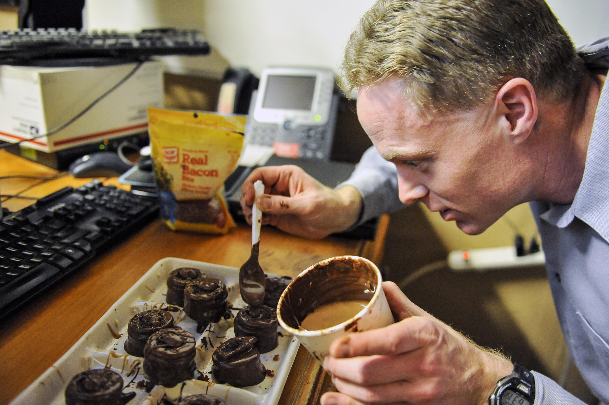 Dan Johnson, the 455th Expeditionary Mission Support Group contract augmentation program manager and treat maker, makes a batch of "Dead Elvis" at Bagram Airfield, Afghanistan, on Feb. 16, 2016. The "Dead Elvis" is a deployed confection created using peanut butter Oreos, bacon and chocolate. (U.S. Air Force photo/Tech. Sgt. Nicholas Rau)