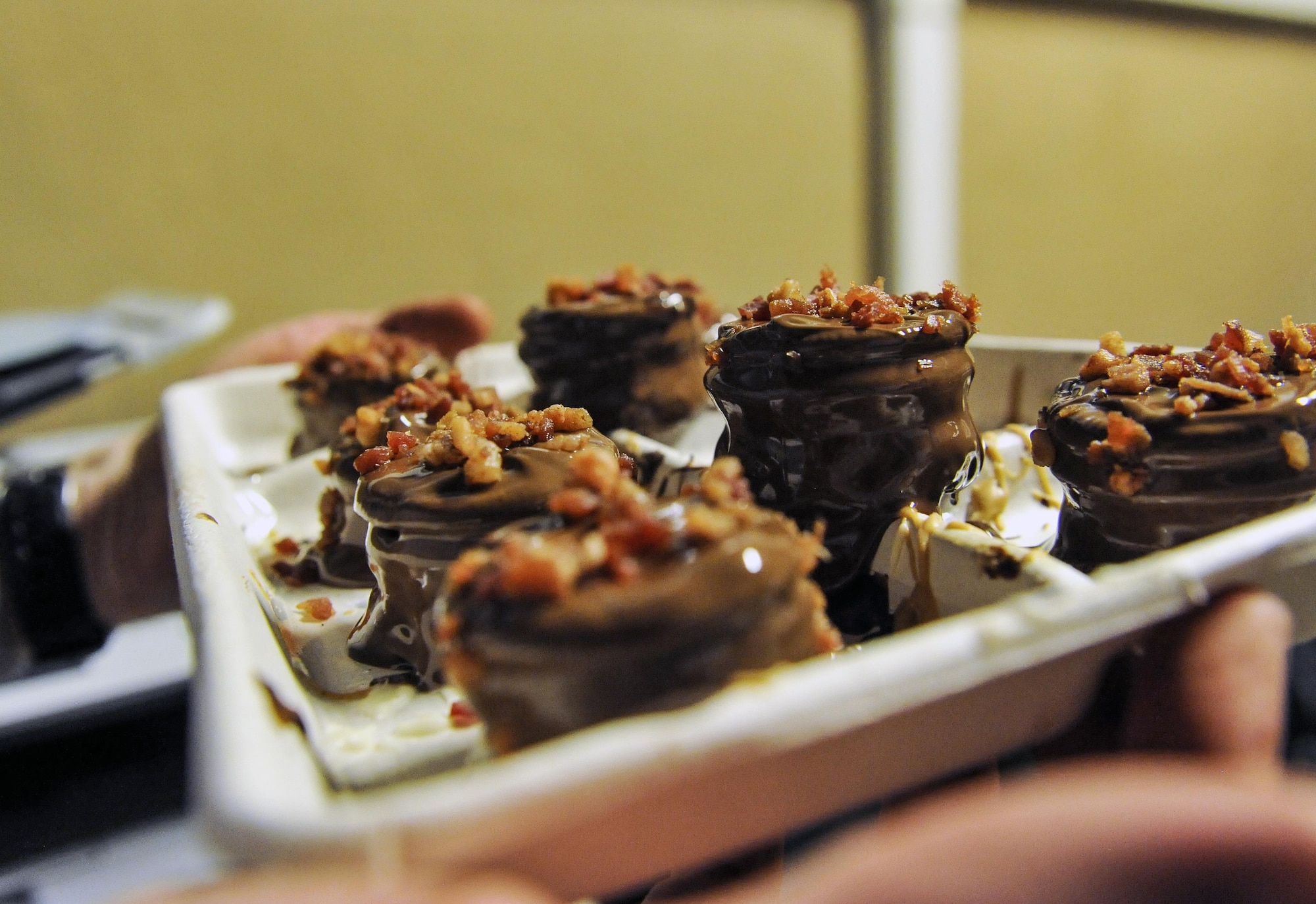 Dan Johnson, the 455th Expeditionary Mission Support Group contract augmentation program manager and treat maker, makes a batch of "Dead Elvis" at Bagram Airfield, Afghanistan, on Feb. 16, 2016. The "Dead Elvis" is a deployed confection created using peanut butter Oreos, bacon and chocolate. (U.S. Air Force photo/Tech. Sgt. Nicholas Rau)