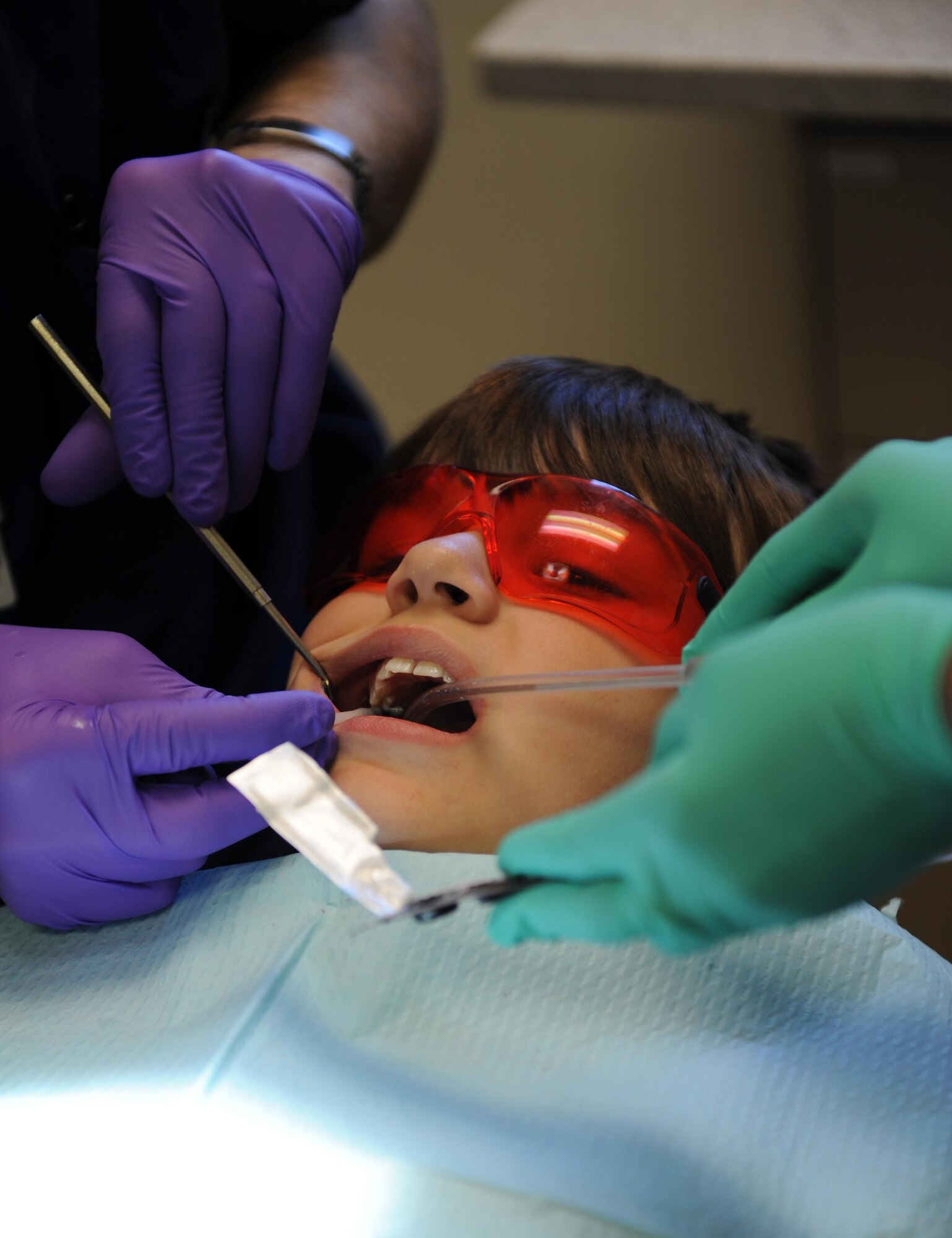 Brady Jackson, son of Tech. Sgt. Shane Jackson, 338th Training Squadron instructor, receives a dental exam during the 6th annual Give Kids a Smile Day at the dental clinic Feb. 10, 2016, Keesler Air Force Base, Miss. The event included dental exams and cleanings for 120 children age2 and older. The clinic provided approximately $80,000 in care during the free screening. (U.S. Air Force photo by Kemberly Groue)