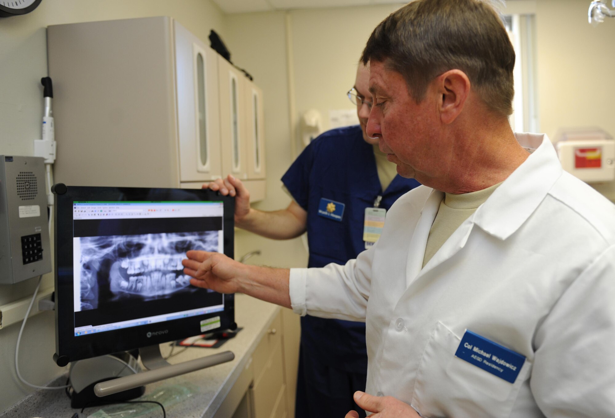 Maj. (Dr.) Michael Majdowicz, 81st Dental Squadron advanced education in general dentistry program director, and Capt. (Dr.) Wyeth Hoopes, 81st DS advanced education in general dentistry resident, review an X-Ray during the 6th annual Give Kids a Smile Day at the dental clinic Feb. 10, 2016, Keesler Air Force Base, Miss. The event included dental exams and cleanings for 120 children age 2 and older. The clinic provided approximately $80,000 in care during the free screening. (U. S. Air Force photo by Kemberly Groue)
