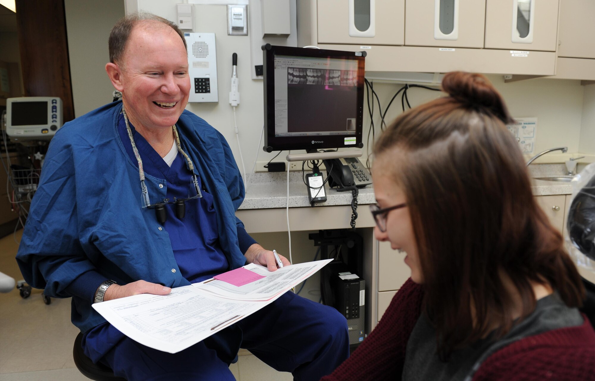 Dr. John McCann, 81st Dental Squadron dentist, speaks with Alexis Meyers, daughter of U.S. Navy Chief Petty Officer John Meyers, Naval Mobile Construction Battalion 11 Bravo Company chief, following her dental exam during the 6th annual Give Kids a Smile Day at the dental clinic Feb. 10, 2016, Keesler Air Force Base, Miss. The event included dental exams and cleanings for 120 children age 2 and older. The clinic provided approximately $80,000 in care during the free screening. (U.S. Air Force photo by Kemberly Groue)