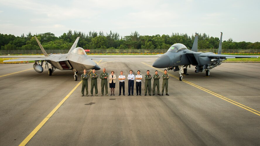 Gen. Lori J. Robinson, Pacific Air Forces commander, Maj. Gen. Hoo Cher Mou, Singapore Chief of Air Force, Heidi Grant, Deputy Under Secretary of the Air Force for International Affairs and pilots from the Singapore and U.S. Air Force pose for a group photo in front of an F-22A Raptor and F-15SG Strike Eagle during the Singapore International Airshow, at Changi International Airport Singapore, Feb. 17, 2016. Singapore is a strong partner with the U.S. that provides mutual training a cooperation opportunities between the two nations’ military forces. (U.S. Air Force photo by Capt. Raymond Geoffroy/Released)