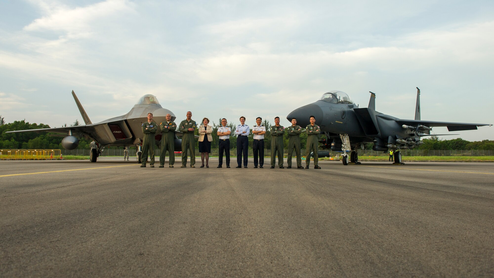 Gen. Lori J. Robinson, Pacific Air Forces commander, Maj. Gen. Hoo Cher Mou, Singapore Chief of Air Force, Heidi Grant, Deputy Under Secretary of the Air Force for International Affairs and pilots from the Singapore and U.S. Air Force pose for a group photo in front of an F-22A Raptor and F-15SG Strike Eagle during the Singapore International Airshow, at Changi International Airport Singapore, Feb. 17, 2016. Singapore is a strong partner with the U.S. that provides mutual training a cooperation opportunities between the two nations’ military forces. (U.S. Air Force photo by Capt. Raymond Geoffroy/Released)