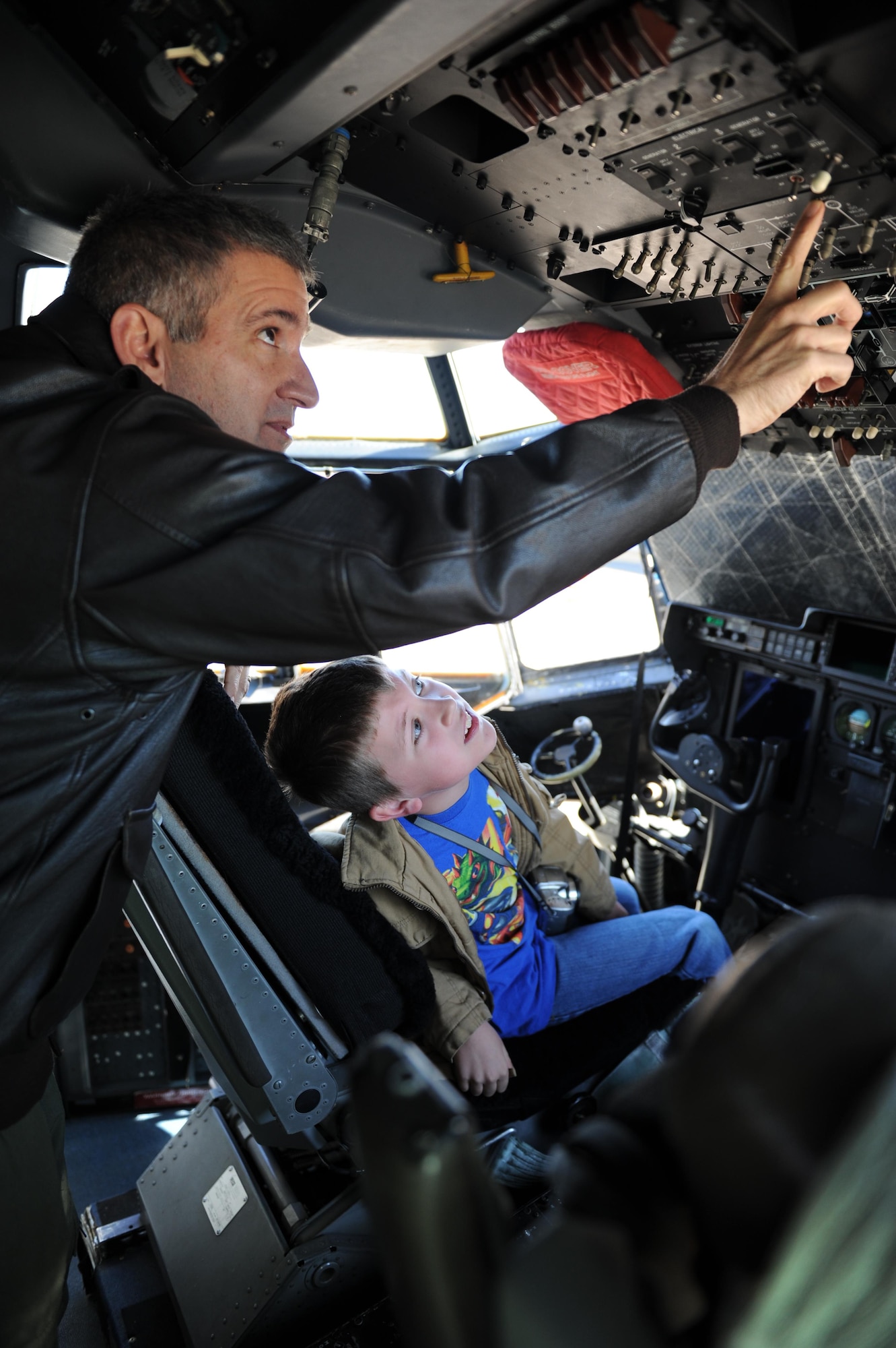 Lt. Col. Jeff Ragusa, 53rd Weather Reconnaissance Squadron instructor evaluator pilot, gives Perry Weller, Biloxi school system student, a tour inside a C-130J Hercules cockpit during Biloxi Career Exploration Day Feb. 11, 2016, Keesler Air Force Base, Miss. The school-aged children also toured the 334th Training Squadron’s air traffic control school, 335th TRS weather facility, 81st Security Forces Squadron canine facility and the Keesler Fire Department. (U.S. Air Force photo by Kemberly Groue)