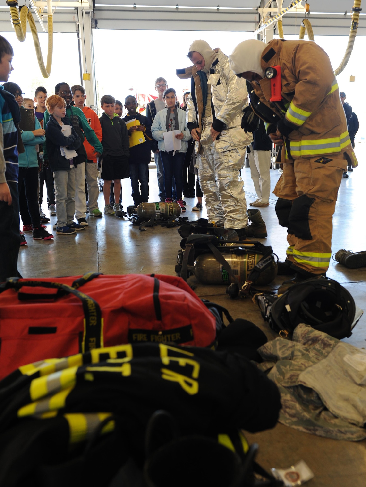 School-aged children watch Keesler firefighters during a bunker gear competition at the fire department during Biloxi Career Exploration Day Feb. 11, 2016, Keesler Air Force Base, Miss. The children also toured the 334th Training Squadron’s air traffic control school, 335th TRS weather facility, 53rd Weather Reconnaissance Squadron and the 81st Security Forces Squadron canine facility. (U.S. Air Force photo by Kemberly Groue)