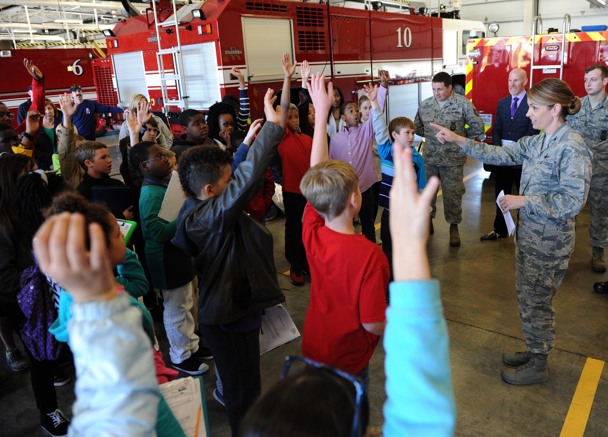 Col. Michele Edmondson, 81st Training Wing commander, quizzes school-aged children about their visit to the base during Biloxi Career Exploration Day Feb. 11, 2016, Keesler Air Force Base, Miss. The children toured the 335th Training Squadron weather facility, 81st Security Forces Squadron canine facility, 53rd Weather Reconnaissance Squadron and the Keesler Fire Department. (U.S. Air Force photo by Kemberly Groue)