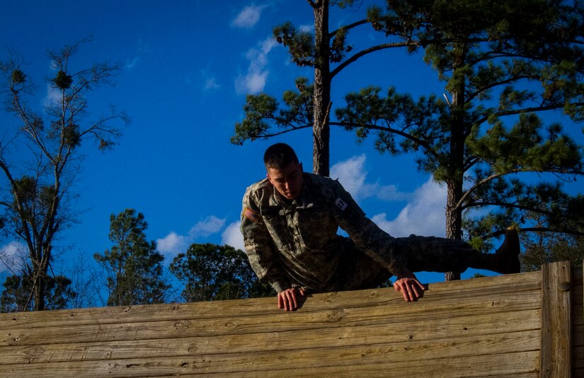 Spc. Alexander Cranick, with the 384th Military Police Battalion, from Springfield, Ill., clears a wall during an obstacle course at this year's 200th Military Police Command Best Warrior Competition held at Camp Blanding, Fla., Feb. 9. The winning noncommissioned officer and junior enlisted Soldiers will move on to the U.S. Army Reserve Command competition in May. (U.S. Army Photo by Sgt. Audrey Ann Hayes)