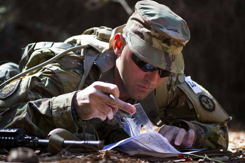 Sgt. Joseph Oneto, a military police officer with the 724th Military Police Detainee Operations Battalion from Naples, Fla., plots points during a land navigation event at Camp Blanding, Fla., Feb. 9. The land navigation event is part of this year's 200th Military Police Command Best Warrior Competition, composed of U.S. Army Soldiers representing 32 states. The winning noncommissioned officer and junior enlisted Soldiers will move on to the U.S. Army Reserve Command competition in May. (U.S. Army Photo by Sgt. Audrey Ann Hayes)