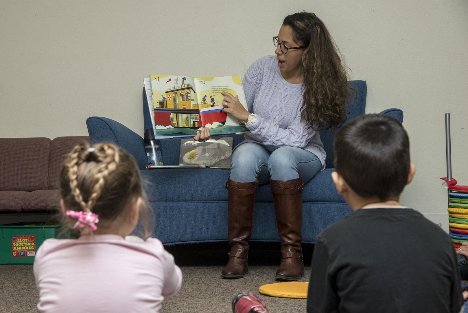 Melanie Torres, Joint Base San Antonio-Randolph Library volunteer, reads a book to children Feb. 3 at the JBSA-Randolph Library. Active-duty service members, dependents, military retirees and Department of Defense cardholders have access to 142,000 items of resources, including books, audio books, DVDs, video games, children’s books, e-readers, magazines and newspapers at the JBSA-Randolph Library.