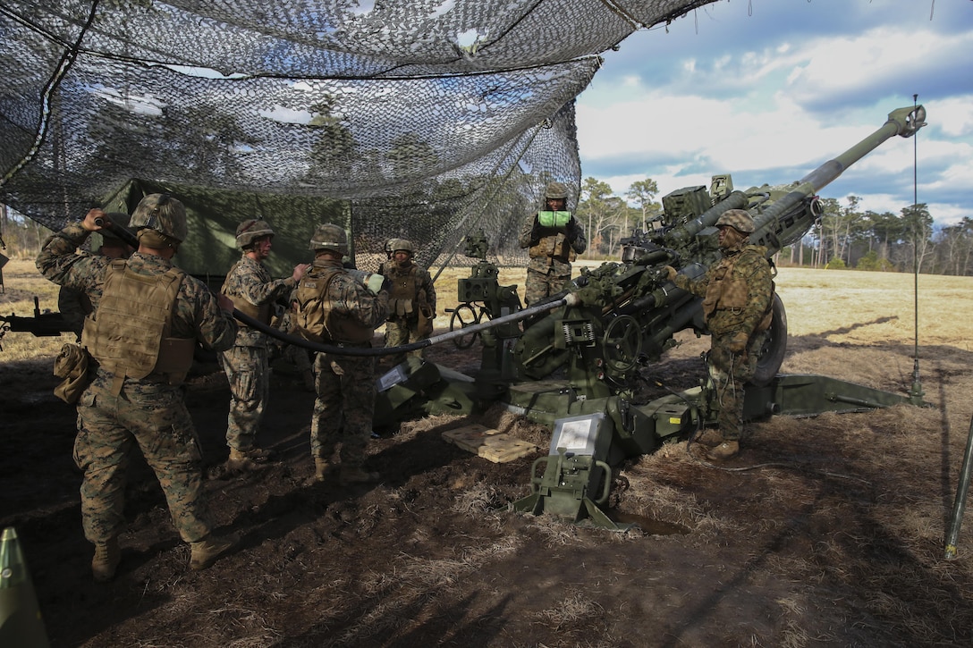Marines with 1st Battalion, 10th Marine Regiment prepare to load an M777A2 howitzer during a fire mission to support Tactical Air Control Party students during a training exercise at Camp Lejeune, N.C., Feb. 9, 2016. Firing in support of a TACP forced the Marines to operate at another unit’s request with aircraft flying in the area, requiring close communication between all parties involved.