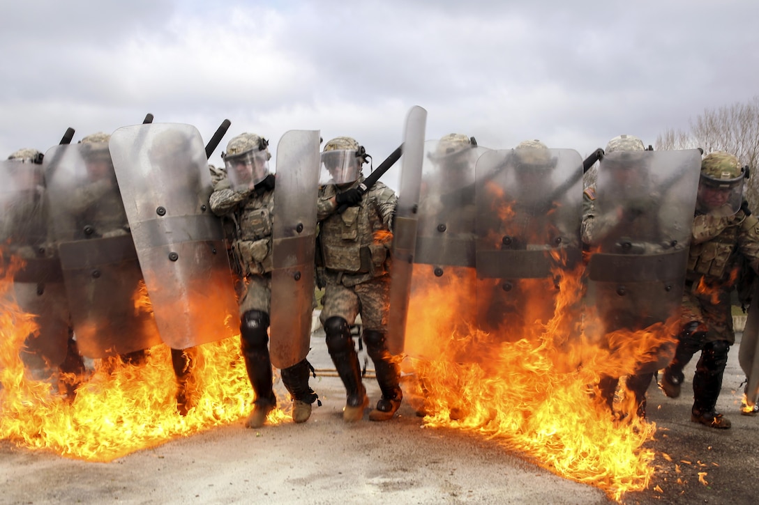 U.S. soldiers march through fire while conducting fire phobia training at the Joint Multinational Readiness Center in Hohenfels, Germany, Feb. 16, 2016. The soldiers are assigned to the 4th Infantry Division’s Alpha Company, 1st Battalion, 41st Infantry Regiment, 2nd Infantry Brigade Combat Team. Army photo by Spc. Lloyd Villanueva