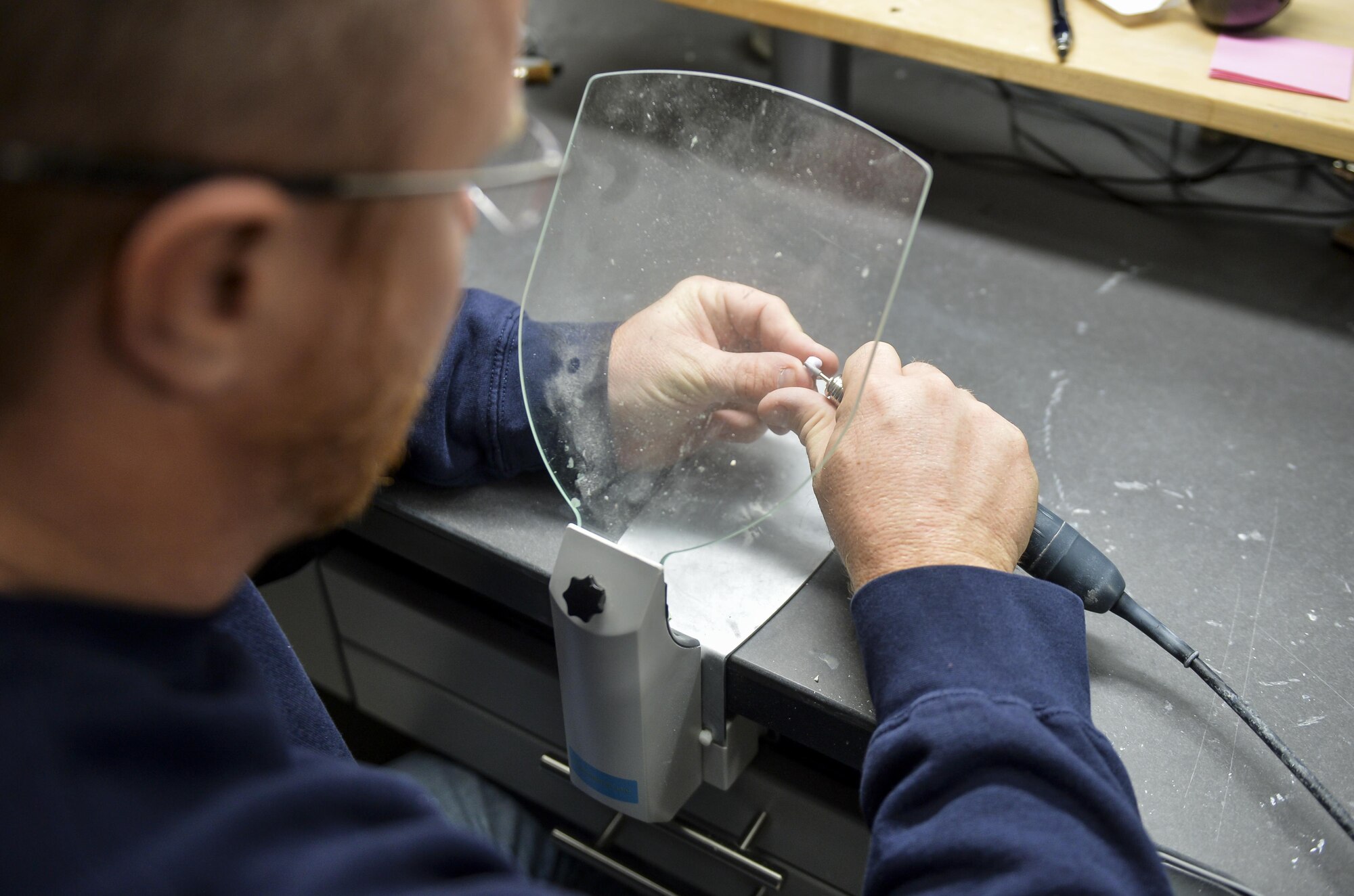 Denny Shaffer, 2nd Dental Squadron laboratory technician, applies finishing touches to a recently milled crown at Barksdale Air Force Base, La., Feb. 12, 2016. Shaffer manually applied finishing touches to the crown by making a series of adjustments to provide the patient with a proper fit. (U.S. Air Force photo/Airman 1st Class Mozer O. Da Cunha)
