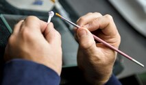 Denny Shaffer, 2nd Dental Squadron laboratory technician, applies glaze to a crown at Barksdale Air Force Base, La., Feb. 12, 2016. The glaze gave the crown a natural look and feel to blend with other natural teeth. (U.S. Air Force photo/Airman 1st Class Mozer O. Da Cunha)